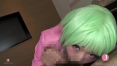 Adorable cosplay girl with green hair performs oral sex on a large penis